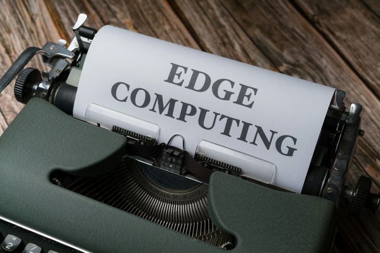 Closeup of a typewriter with a paper reading "edge computing"
