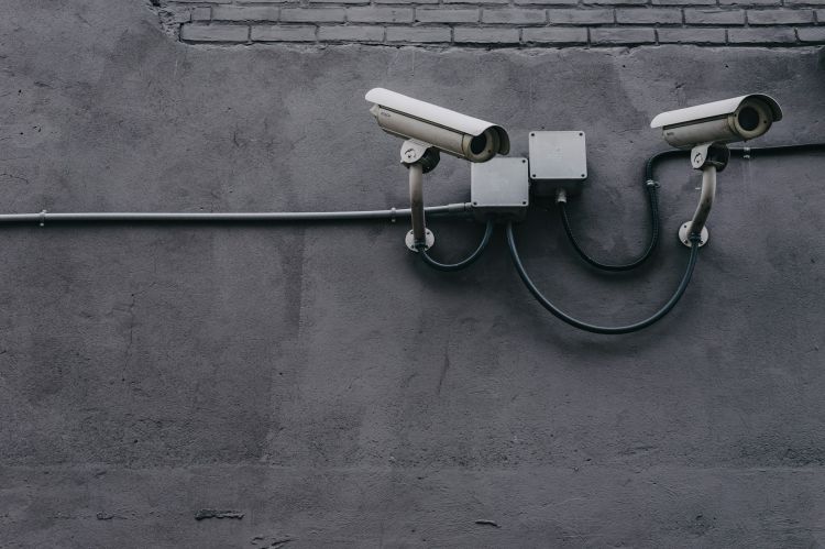 Two surveillance cameras attached to a wall