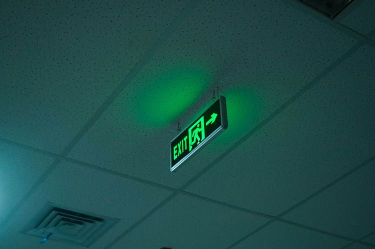 Green exit sign on ceiling