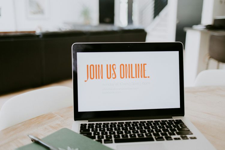 A laptop screen that reads "Join Us Online"