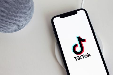 Display of TikTok on phone laying on desk. Source: https://pixabay.com/images/id-5064078/