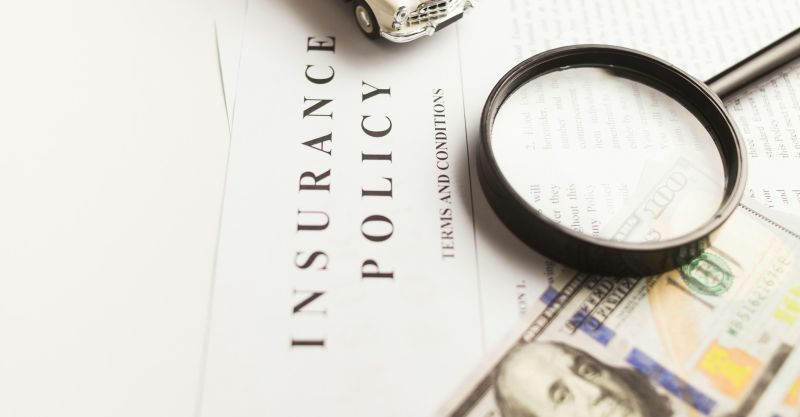 Closeup of a paper with the headline "Insurance Policy"