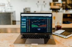 laptop on a desk showing financial data