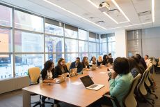 A group of businesspeople sitting at a conference table.