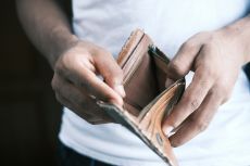Closeup of a man holding open an empty wallet